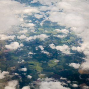 Aerial view of Ireland, peeking through clouds.